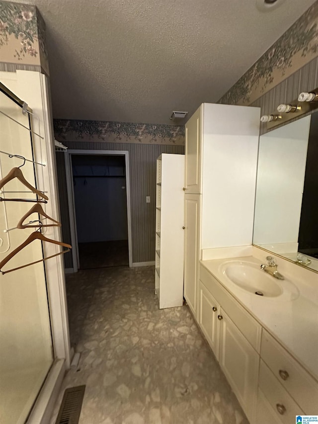 bathroom featuring vanity and a textured ceiling