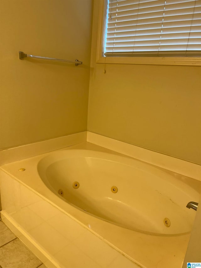 bathroom featuring a tub to relax in and tile patterned flooring