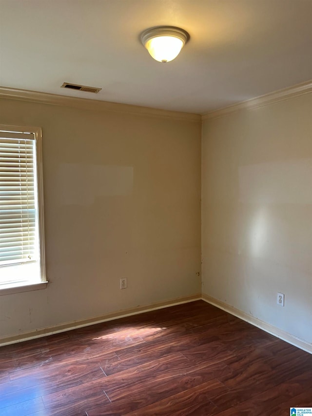 unfurnished room with dark wood-type flooring and ornamental molding