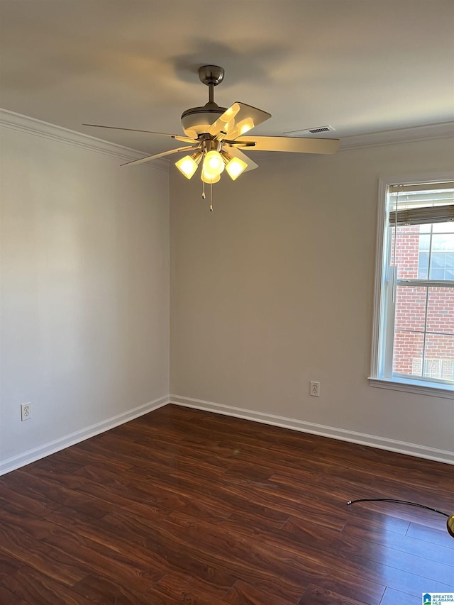 empty room featuring ceiling fan, dark hardwood / wood-style floors, and ornamental molding