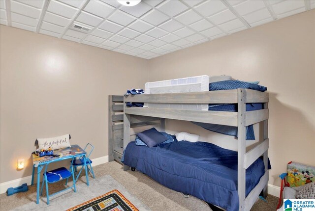 bedroom featuring carpet floors and a paneled ceiling