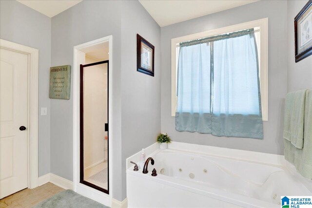 bathroom featuring tile patterned flooring and independent shower and bath