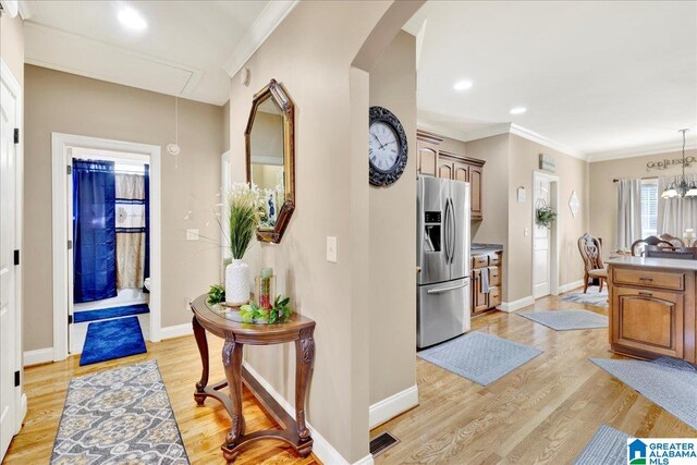 interior space featuring light hardwood / wood-style floors and ornamental molding