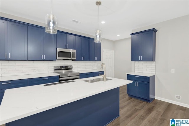 kitchen with pendant lighting, sink, stainless steel appliances, and blue cabinets