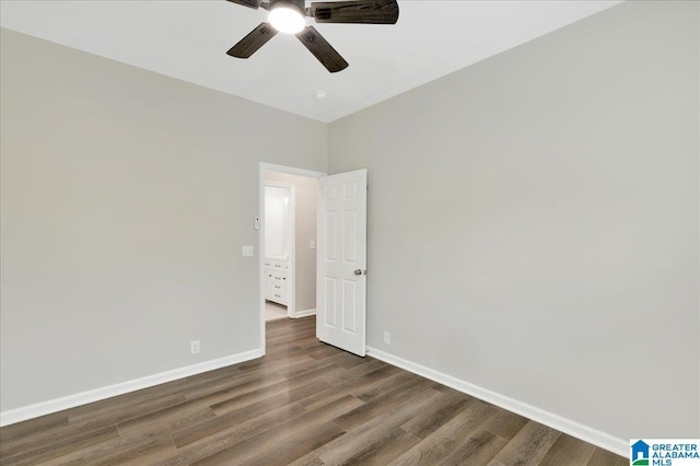 empty room featuring ceiling fan and dark hardwood / wood-style flooring