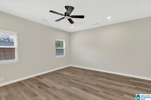 spare room featuring hardwood / wood-style flooring and ceiling fan