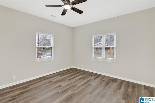 spare room with ceiling fan and wood-type flooring