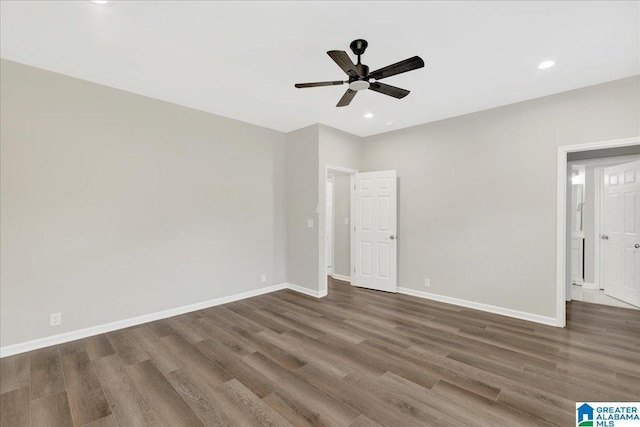 unfurnished bedroom featuring dark wood-type flooring and ceiling fan