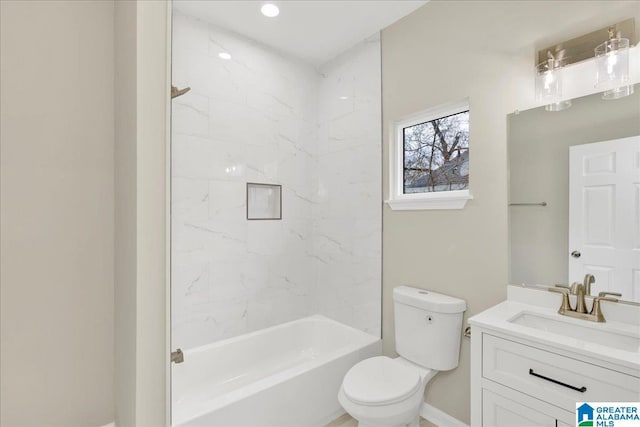 full bathroom with vanity, tiled shower / bath, and toilet