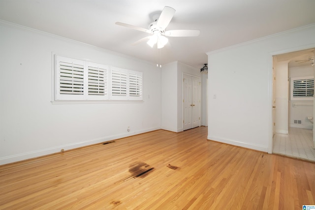 interior space with ceiling fan, crown molding, and light hardwood / wood-style flooring