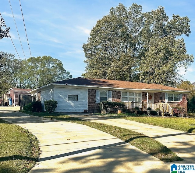 ranch-style home with a front yard and brick siding