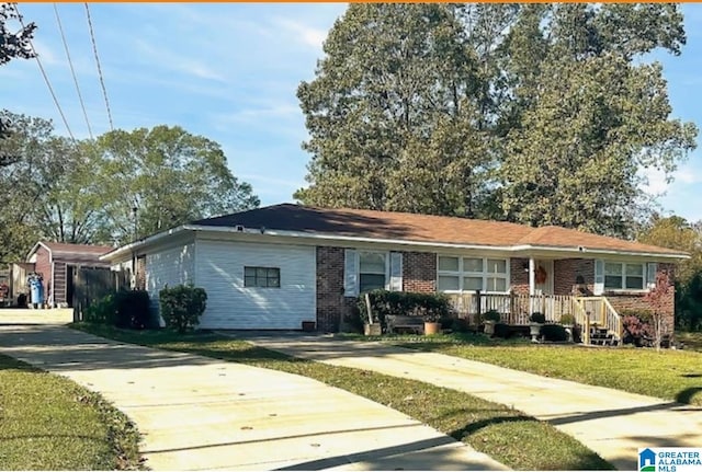 ranch-style house with brick siding and a front yard