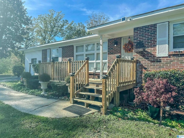 view of exterior entry featuring brick siding