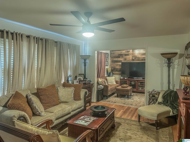 living area with ceiling fan and wood finished floors