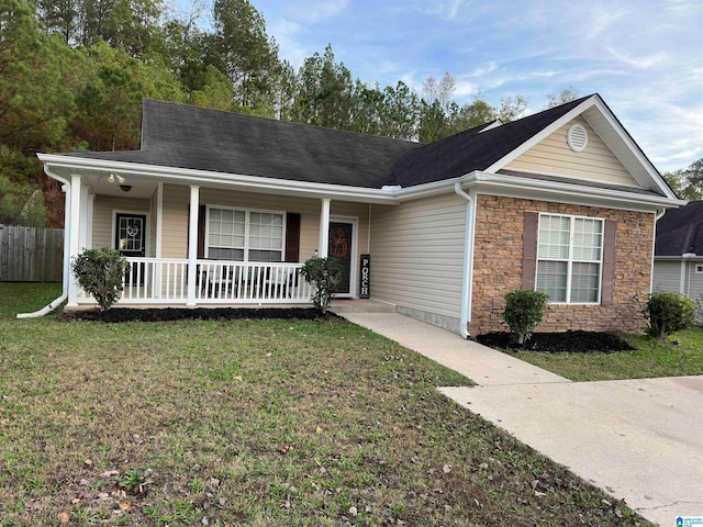 single story home featuring a front lawn and covered porch