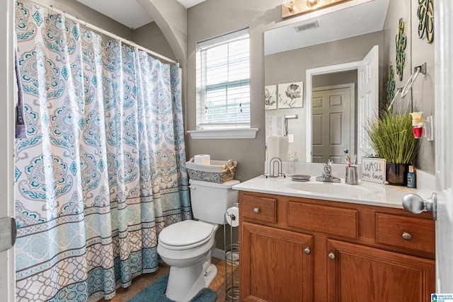 bathroom featuring toilet, a shower with curtain, vanity, and tile patterned floors