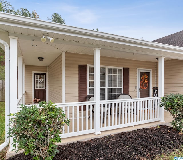 view of exterior entry featuring a porch