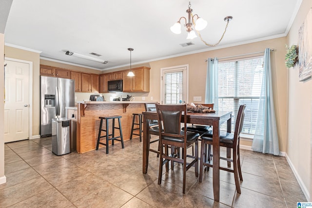 tiled dining space featuring crown molding and a notable chandelier