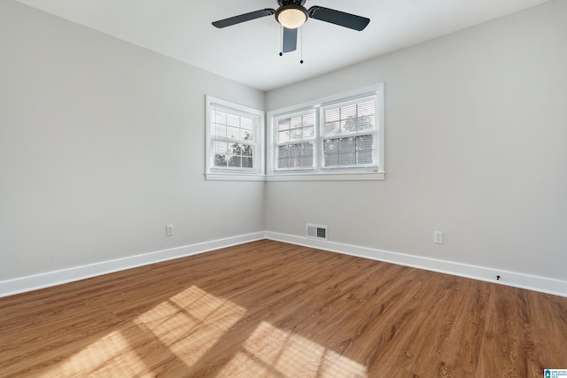 spare room with hardwood / wood-style flooring and ceiling fan