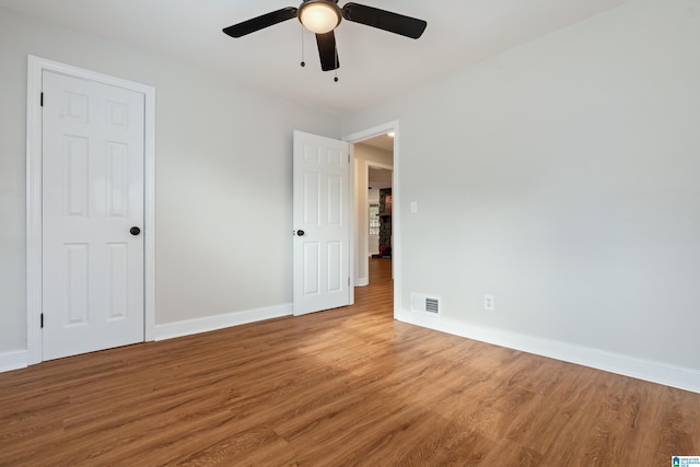 empty room featuring ceiling fan and hardwood / wood-style flooring