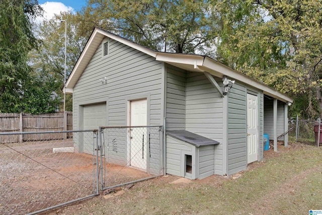 view of side of home with a garage and an outdoor structure