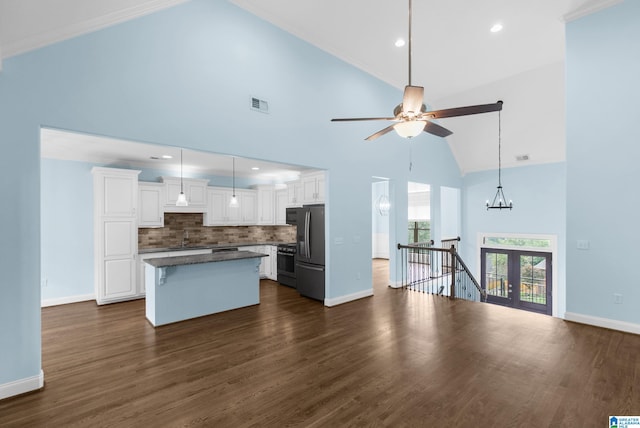 kitchen featuring white cabinetry, a center island, dark hardwood / wood-style flooring, high vaulted ceiling, and appliances with stainless steel finishes