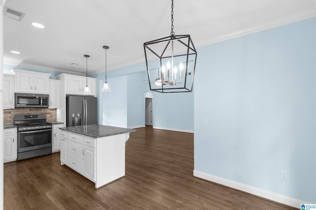 kitchen with white cabinetry, a kitchen island, pendant lighting, and appliances with stainless steel finishes