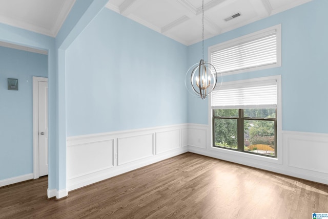 empty room featuring a chandelier, beamed ceiling, hardwood / wood-style flooring, and coffered ceiling