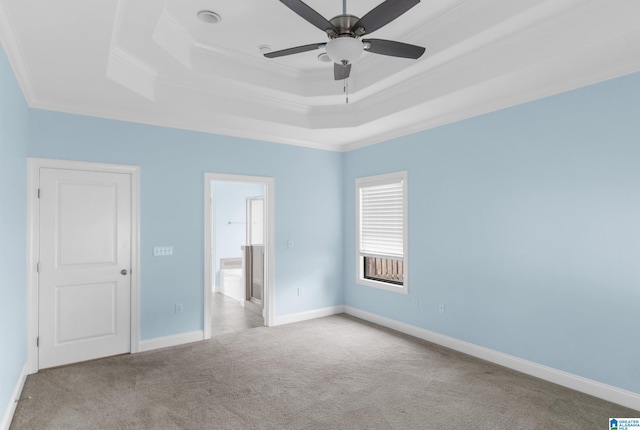 unfurnished bedroom with ceiling fan, a raised ceiling, light colored carpet, and crown molding