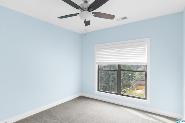 carpeted spare room with ceiling fan