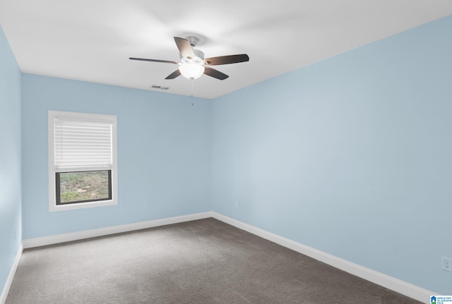 carpeted spare room with ceiling fan