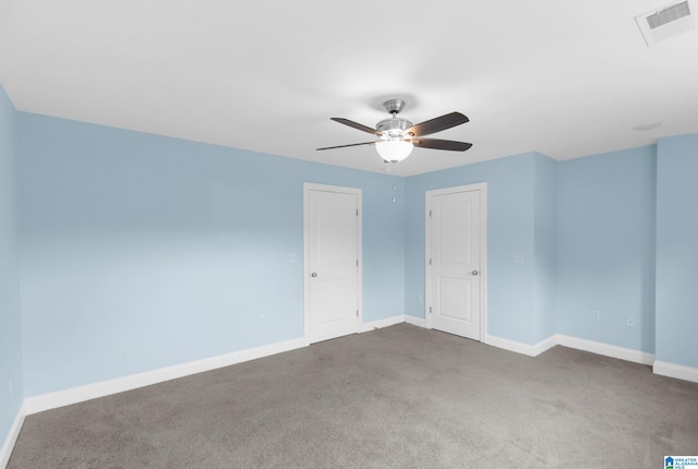 carpeted spare room with ceiling fan