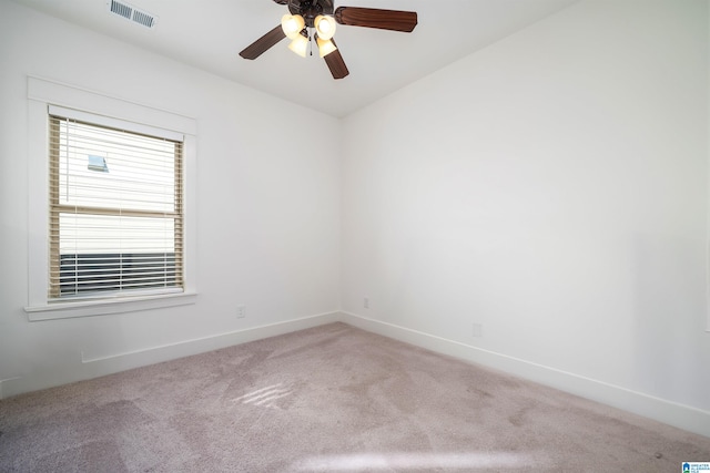 empty room featuring ceiling fan and light colored carpet