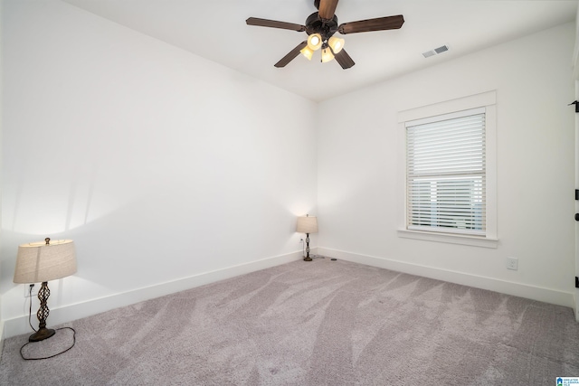 empty room with ceiling fan and carpet floors