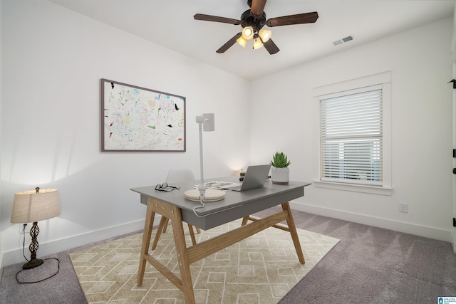 carpeted home office with ceiling fan