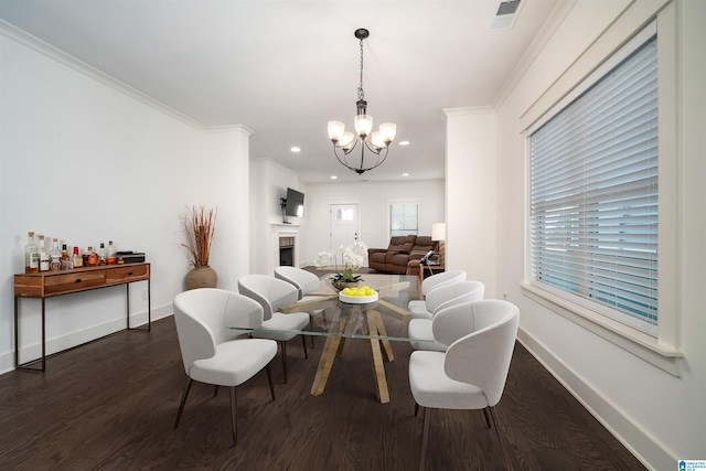 living room featuring a chandelier, dark hardwood / wood-style floors, and ornamental molding