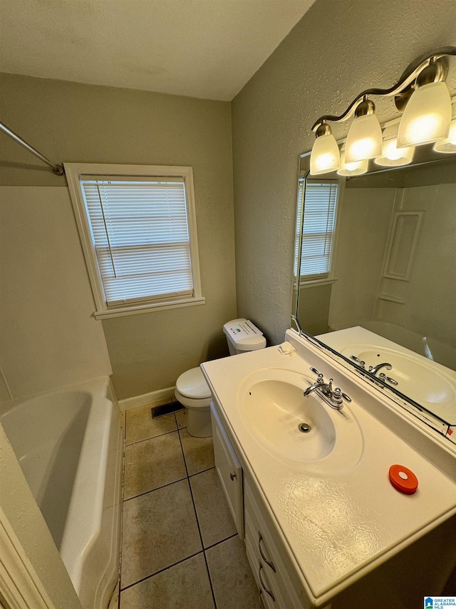 bathroom with tile patterned flooring, vanity, and toilet