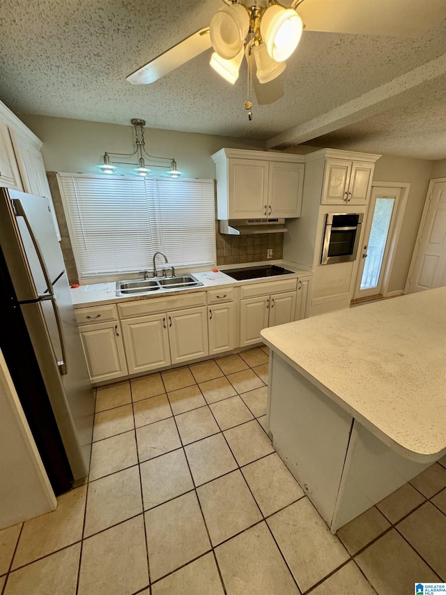 kitchen with stainless steel appliances, ceiling fan, sink, light tile patterned floors, and white cabinets