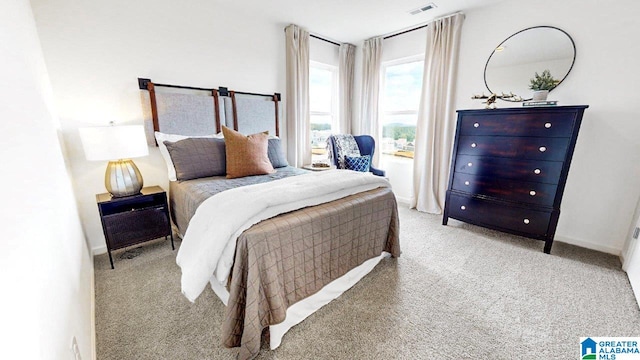 bedroom featuring light colored carpet