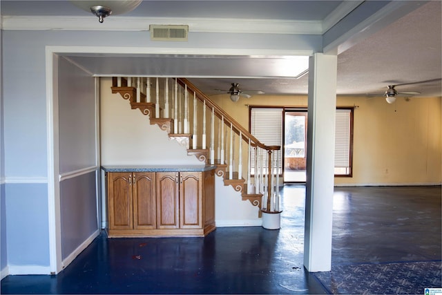 stairs with ceiling fan, concrete flooring, and crown molding