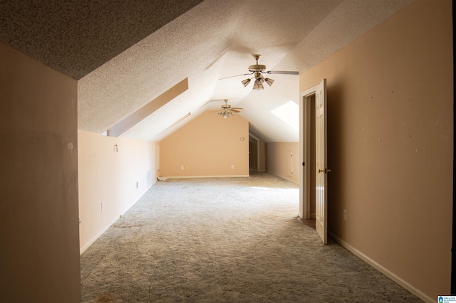 bonus room with carpet flooring, ceiling fan, lofted ceiling, and a textured ceiling