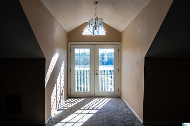 doorway featuring carpet, vaulted ceiling, an inviting chandelier, and french doors