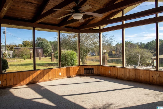 unfurnished sunroom with vaulted ceiling with beams, plenty of natural light, wooden ceiling, and ceiling fan