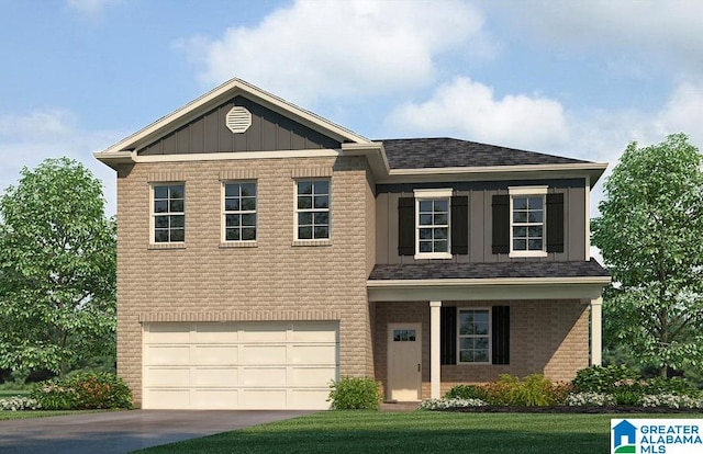 view of front of home featuring a front yard and a garage