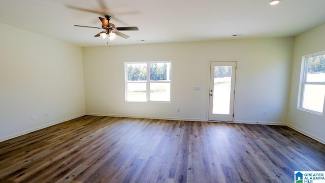 unfurnished room with dark hardwood / wood-style floors and ceiling fan