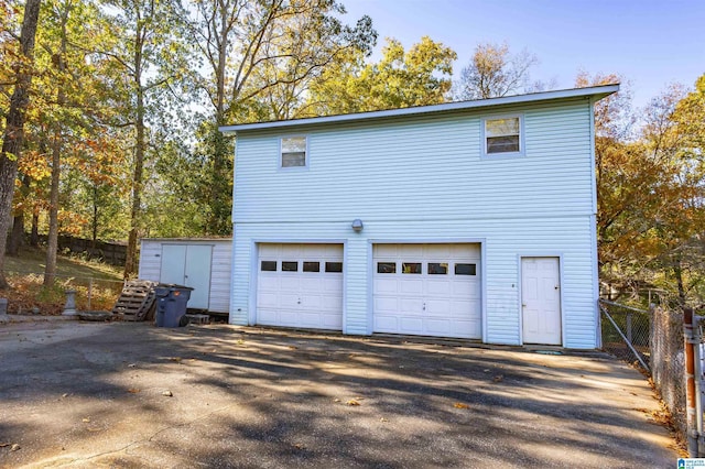 694 Center Point Rd, Sylacauga, AL 35151 - view of side of home featuring driveway, an attached garage, and fence