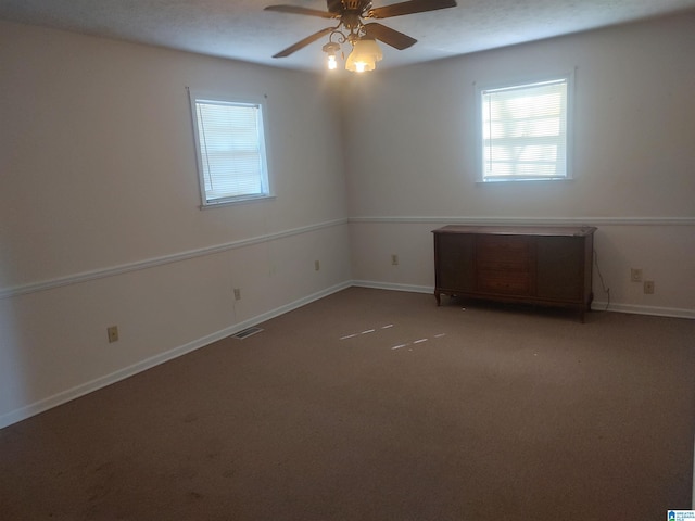 694 Center Point Rd, Sylacauga, AL 35151 - carpeted empty room featuring plenty of natural light, ceiling fan, and baseboards