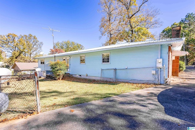 rear view of property with a lawn