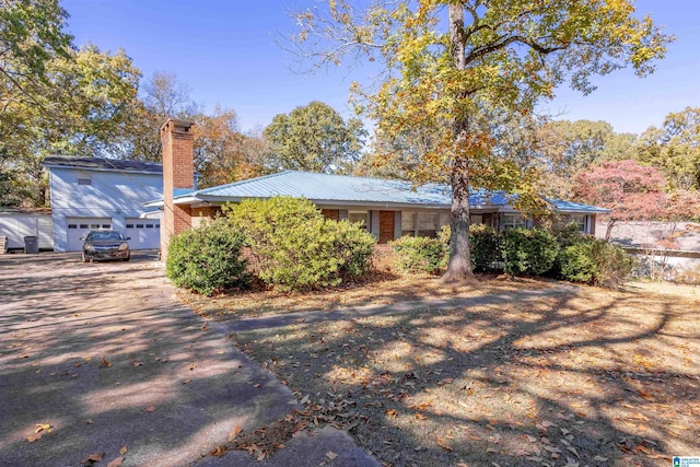 694 Center Point Rd, Sylacauga, AL 35151 - view of front of property featuring a chimney, driveway, and metal roof