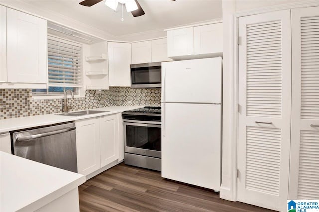 kitchen with white cabinetry, sink, stainless steel appliances, tasteful backsplash, and dark hardwood / wood-style floors